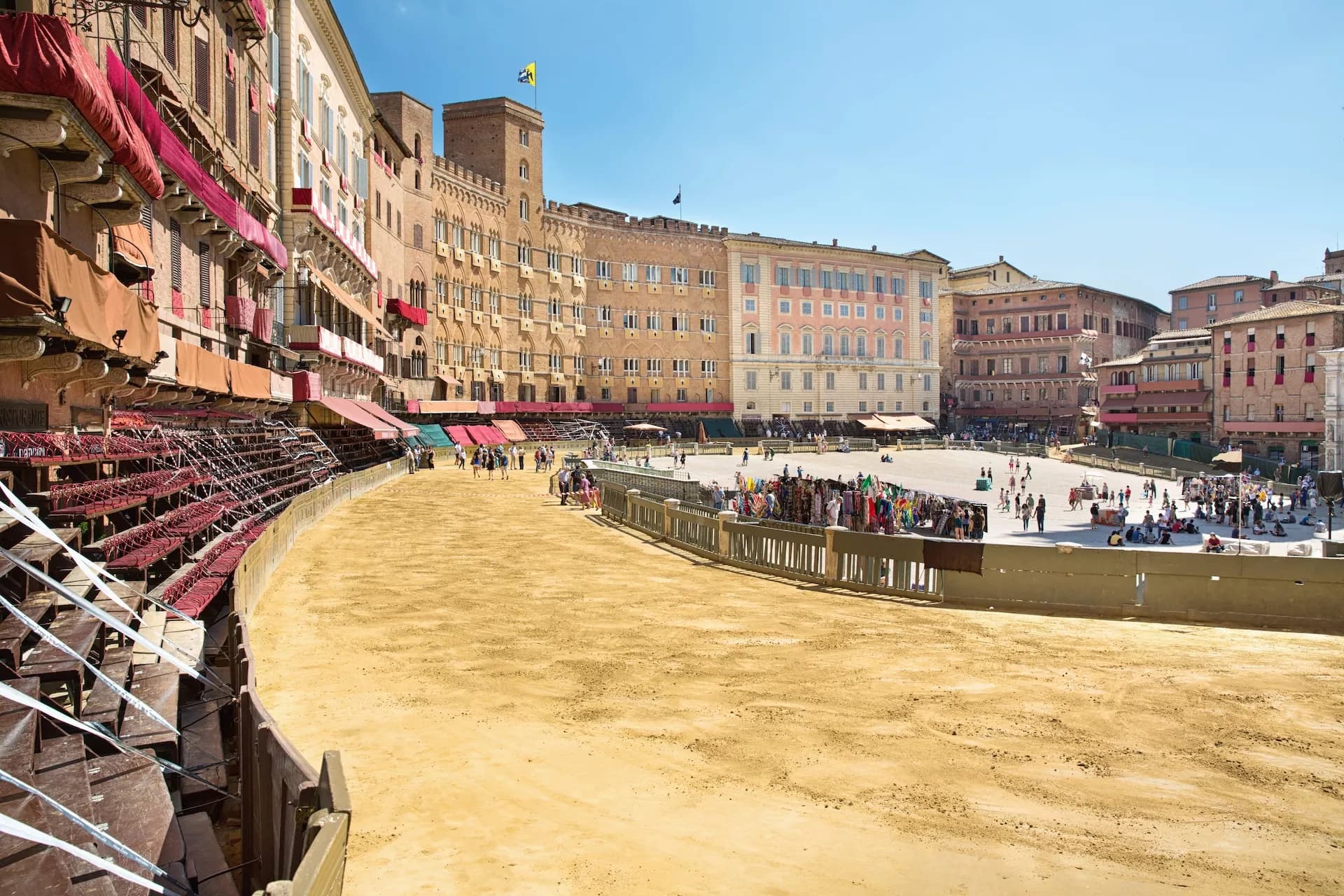 Dirt track with temporary seating and historic buildings in Piazza del Campo, Siena.