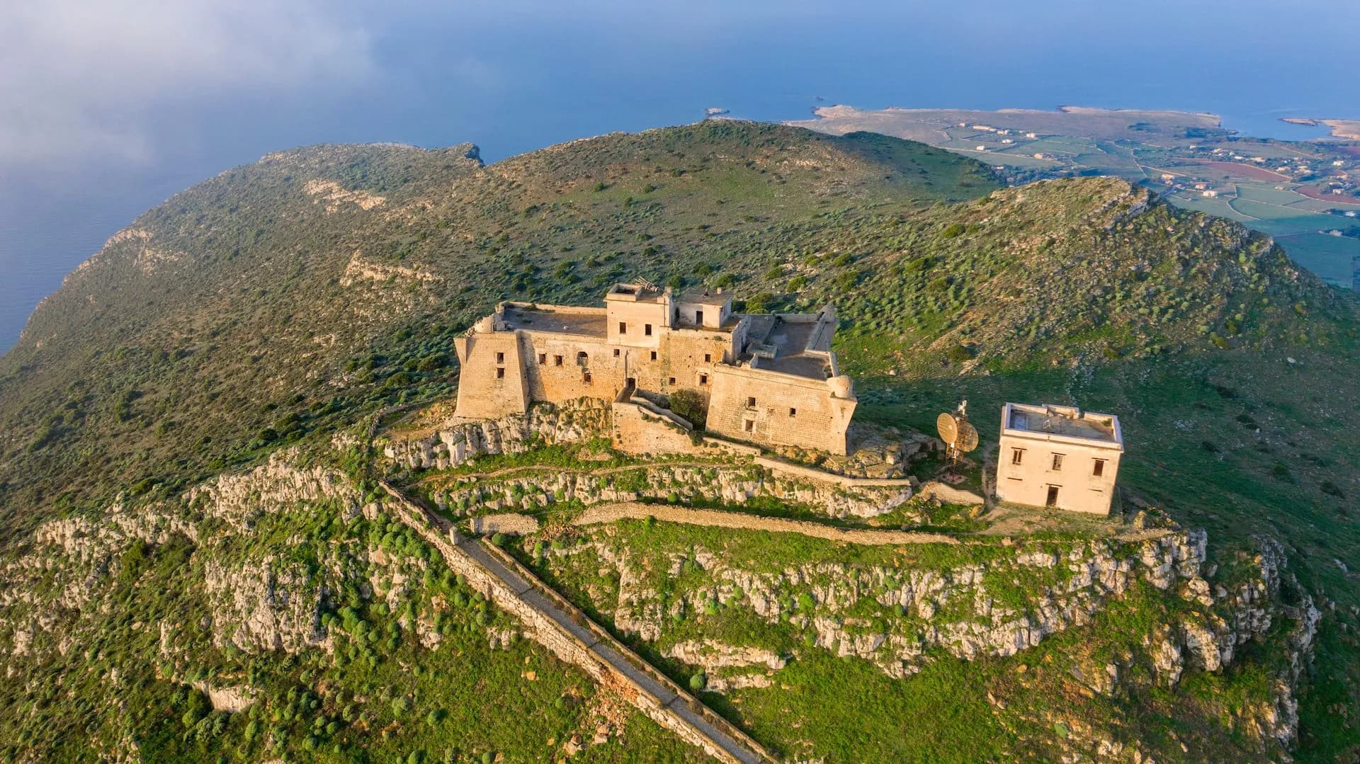 Santa Caterina Castle on a green, rocky hill overlooking the sea on Favignana.