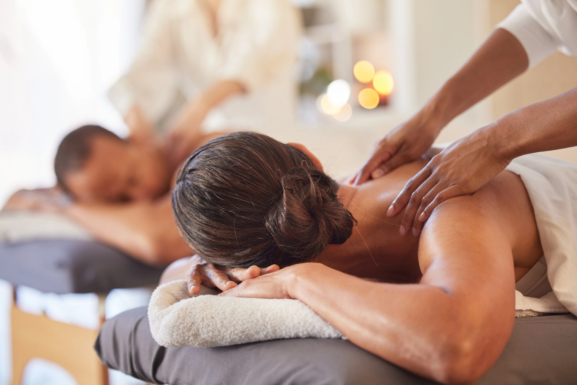 Massage, relax and peace with couple in spa for healing, health and zen treatment. Detox, skincare and beauty with hands of massage therapist on man and woman for calm, physical therapy and luxury