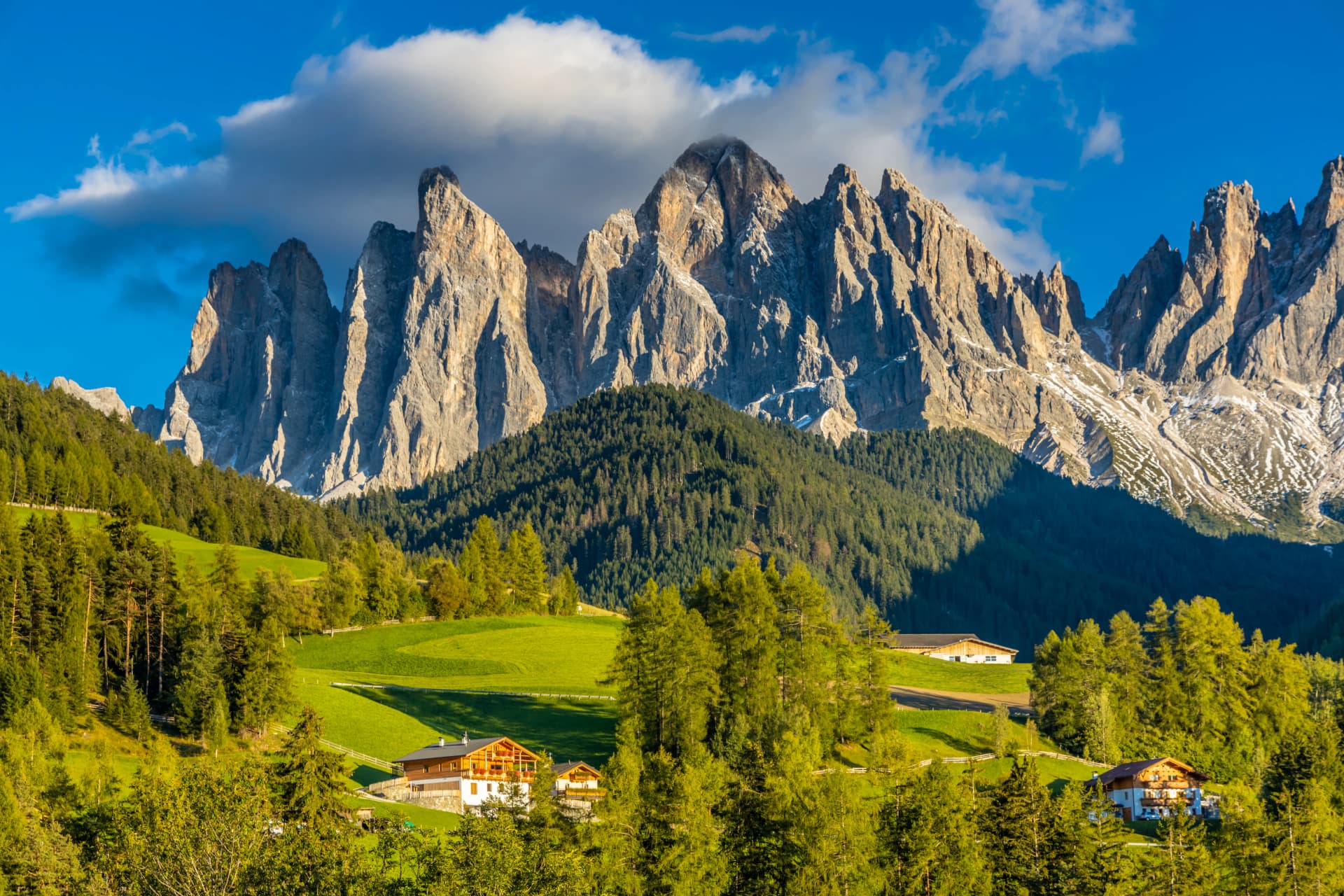 Panorama of Santa Maddalena village and church in the Dolomites, Puez Odle national park in Italy. Italian Dolomiti Alps scenic landscape in summer with beautiful sunlight at sunset
