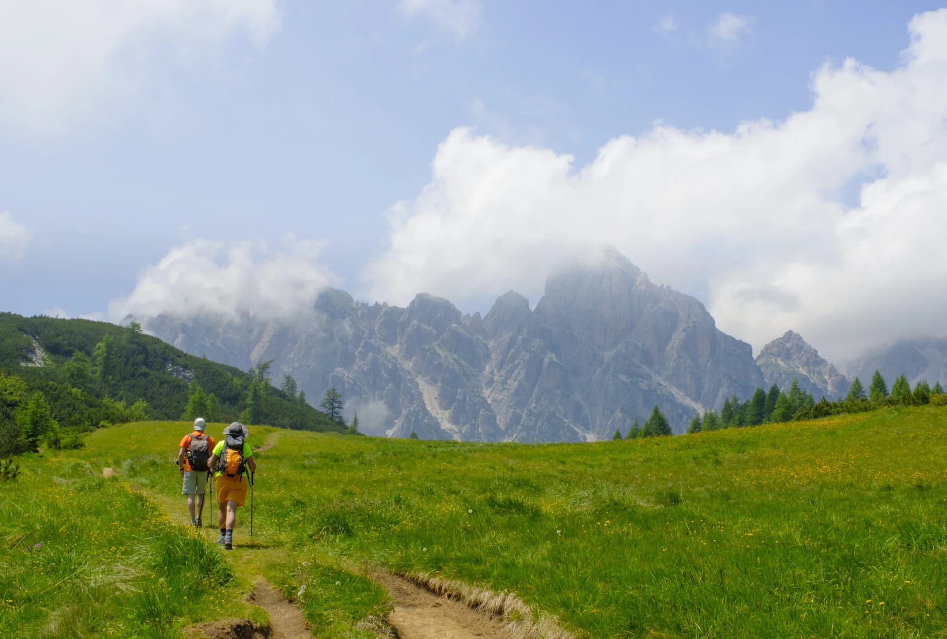 Hikers head for the mountains, Zoldo Valley in the Dolomites, Italy