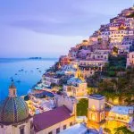 View of the postiano town and the seaside in a summer sunset